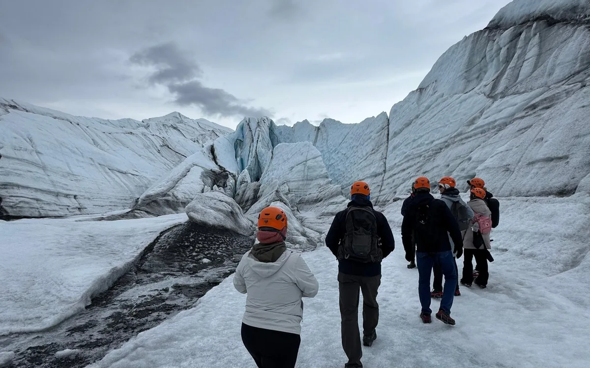 A guide briefing a small group at the terminus of the Matanuska Glacier